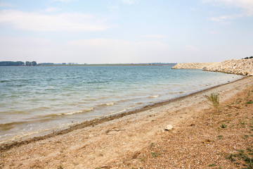 Shore and beach of costesti big blue lake, north of republic of Moldova