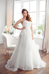 Beautiful bride in gorgeous wedding dress indoors. Wedding fashion