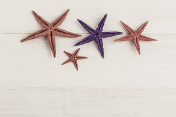 colorful starfishes on wooden surface