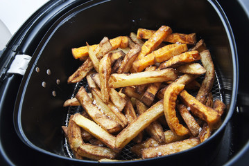 French fries potatoes in the cooking container