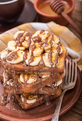 French toasts with banana chocolate sauce and honey.