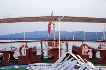 Sunbeds on the ship under the open sky, a lot of plastic beds fo