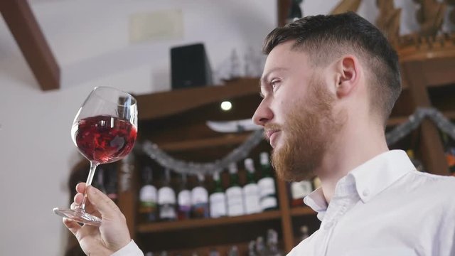 Sommelier tating the wine, slow motion