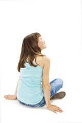 Rear view of little girl sitting on floor. Isolated on white background 