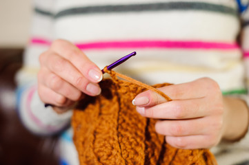 Close up of hands knitting. Process of knitting.