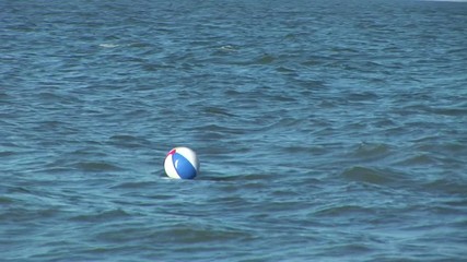 a lost beachball drifts offshore