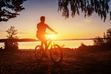 Fototapeta na wymiar boy on a bicycle at sunset