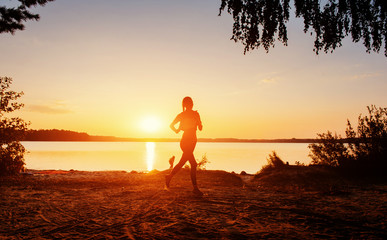 Fototapeta premium girl at sunset by the lake