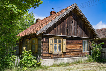 Old wooden russian Philippians house in a polish Masuria. Summer, sunny day, blue sky above.