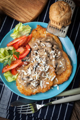 Crispy fried homemade potato pancakes with mushroom sauce.