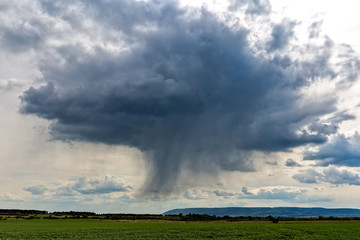 Fototapeta na wymiar Big powerful storm clouds over the land
