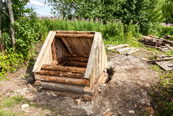 Construction new wooden water well in russian village in summert