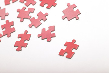 Colorful puzzle pieces on a white surface.