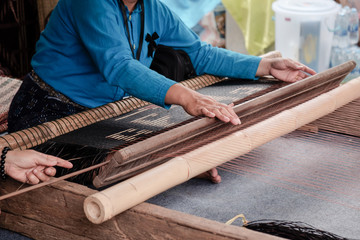 Weaving / View of woman weaving on loom.