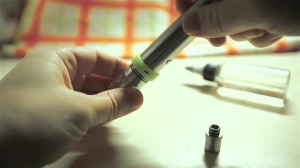 Men's hands siut the electronic cigarette for background.