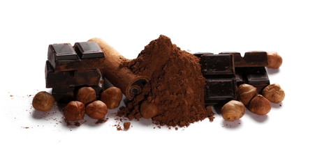 chocolate bars, cocoa powder with cinnamon sticks and pile hazelnuts isolated on white background