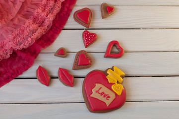 St. Valentines composition. Top view on red honey cakes on wooden table