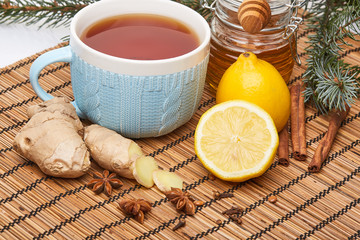 Honey and tea with spices and lemon.