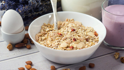 Healthy food muesli with banana, nuts and milk for breakfast
