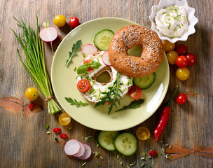 Vegetarian bagel sandwich with fresh veggies and arugula salad,healthy snack