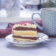 Close up shot of a piece of a lemon layer cream cake with Valentines Day heart shaped decoration