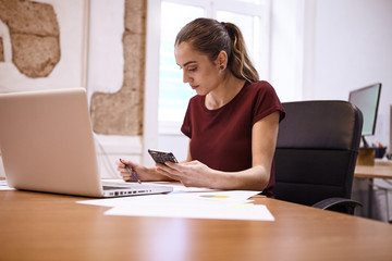 Young business woman making some notes