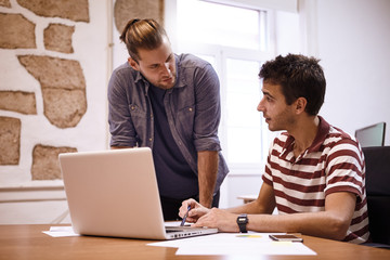 Obraz premium Two concerned business men looking thoughtful