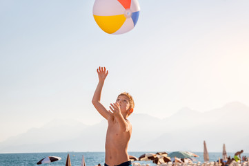 A child playing with beach ball