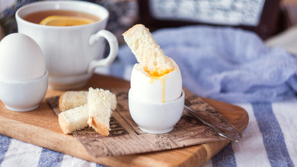 breakfast with boiled eggs and crispy toasts, closeup