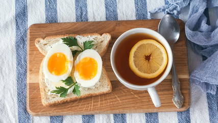freshly boiled white egg on wooden board. Healthy fitness breakfast