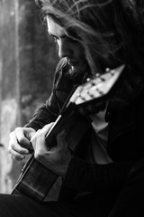 Guitar player playing song outdoor