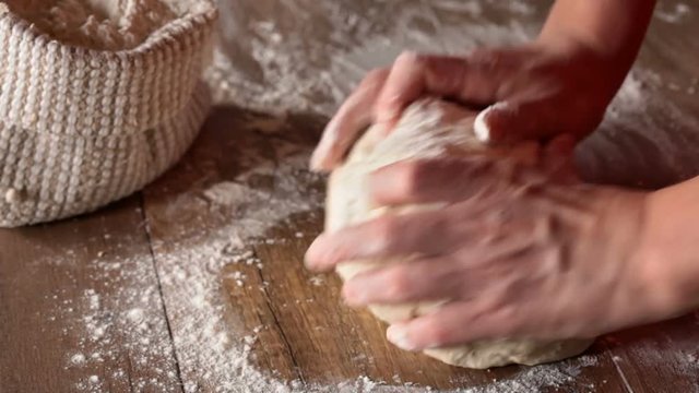 Woman hands kneading the bread dough - closeup, slow slide