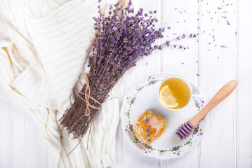 Honey comb on a plate with the Colors of Lavender and tea with lemon.sweet food.selective focus.