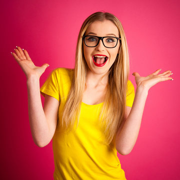 excited young woman over pink background gesture success with ar