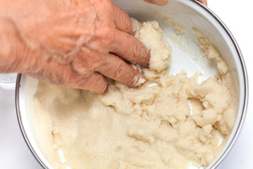 Colombian arepa dough preparation: Knead by hand the cornmeal with water