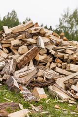 Firewood background - chopped firewood on a stack. Dry chopped firewood logs in a pile. Nature abstract background with stack of firewood.