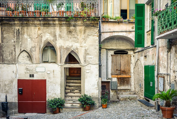 Fototapeta na wymiar Beautiful old facade with shutters on the windows. Italy.
