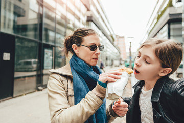 Mother and daughter sharing sandwich