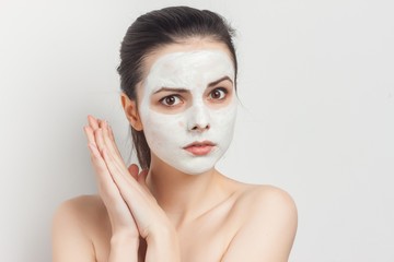 woman with a mask on her face folded her hands together