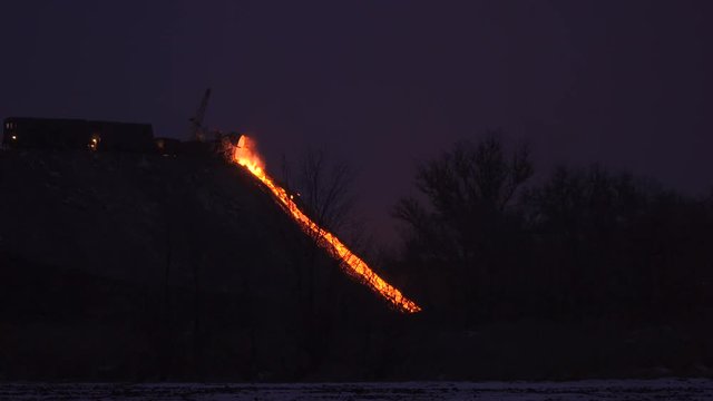 Pour the molten slag in a metallurgical plant. Twilight winter 4K