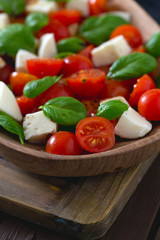 caprese salad on dark wooden surface