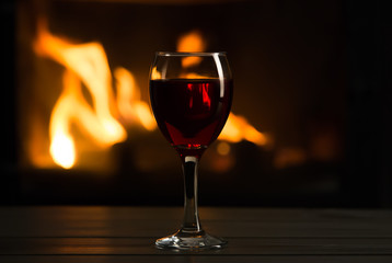 Glass of wine in front of fireplace