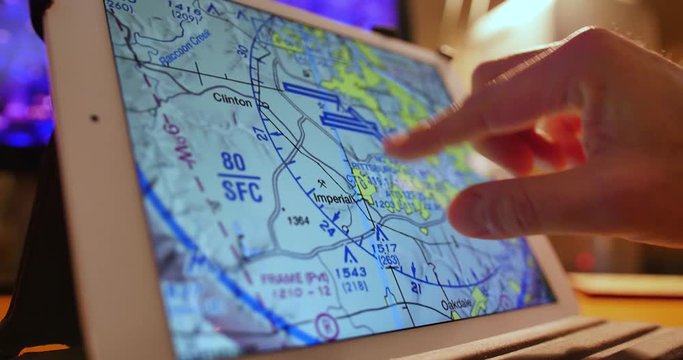 A pilot examines VFR maps of the Pittsburgh area on a tablet PC before a flight.
