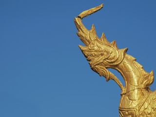Golden Naga or Serpent King statue in buddhist temple.