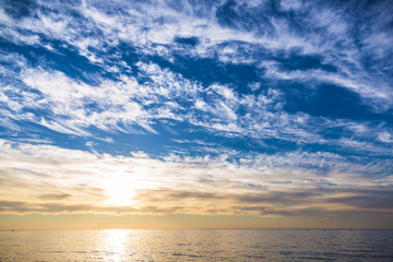 blue sky with clouds and sunset on ocean