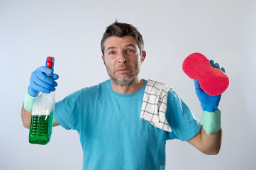 domestic service man or tired husband angry and stressed house cleaning with spray bottle and sponge