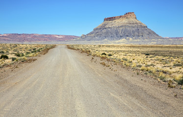 Gravel road through desert landscape