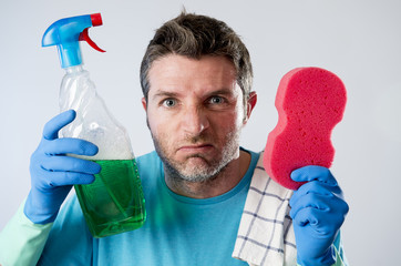 domestic service man or tired husband angry and stressed house cleaning with spray bottle and sponge