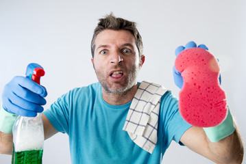 domestic service man or tired husband angry and stressed house cleaning with spray bottle and sponge