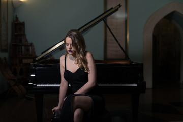 Fototapeta na wymiar Portrait of Woman Playing Piano